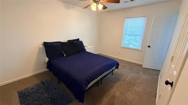 a bed sitting in a bedroom next to a window