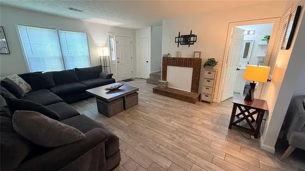 a living room with furniture and wooden floor