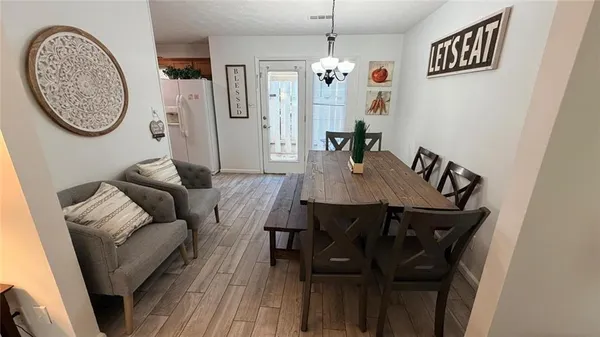 a view of a dining room with furniture and a chandelier