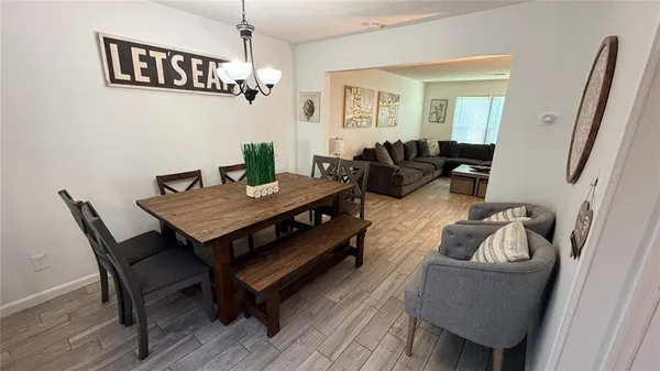 a living room with furniture a window and a chandelier