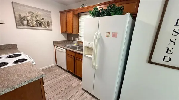 a white refrigerator freezer sitting inside of a kitchen