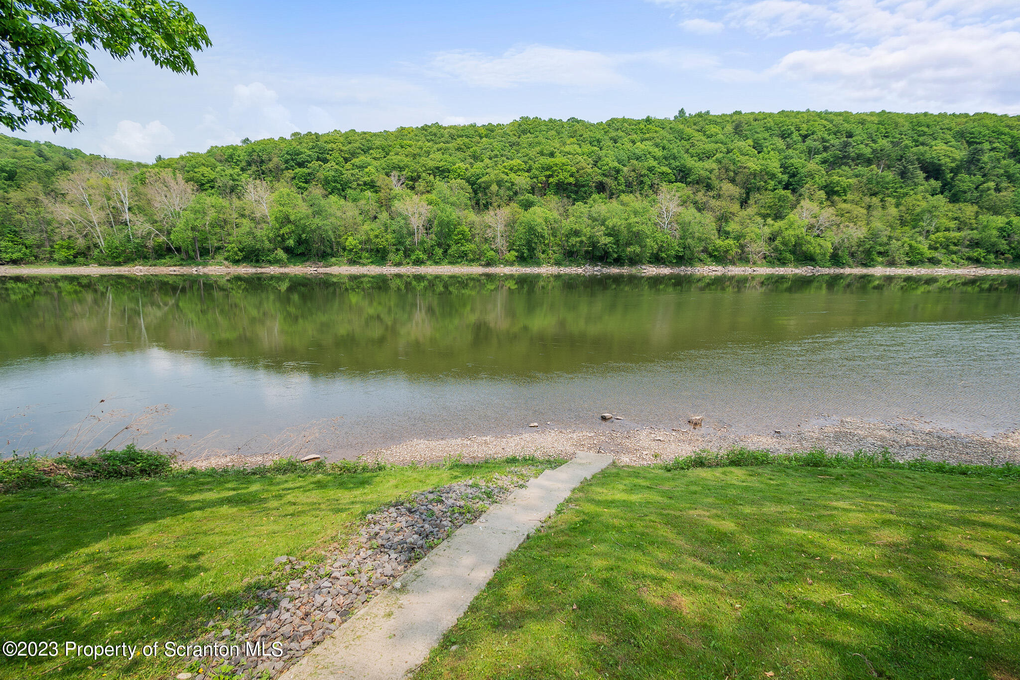 311 River Road Falls, PA 18615 - Photo 2 of 30 a body of water with a yard and large trees