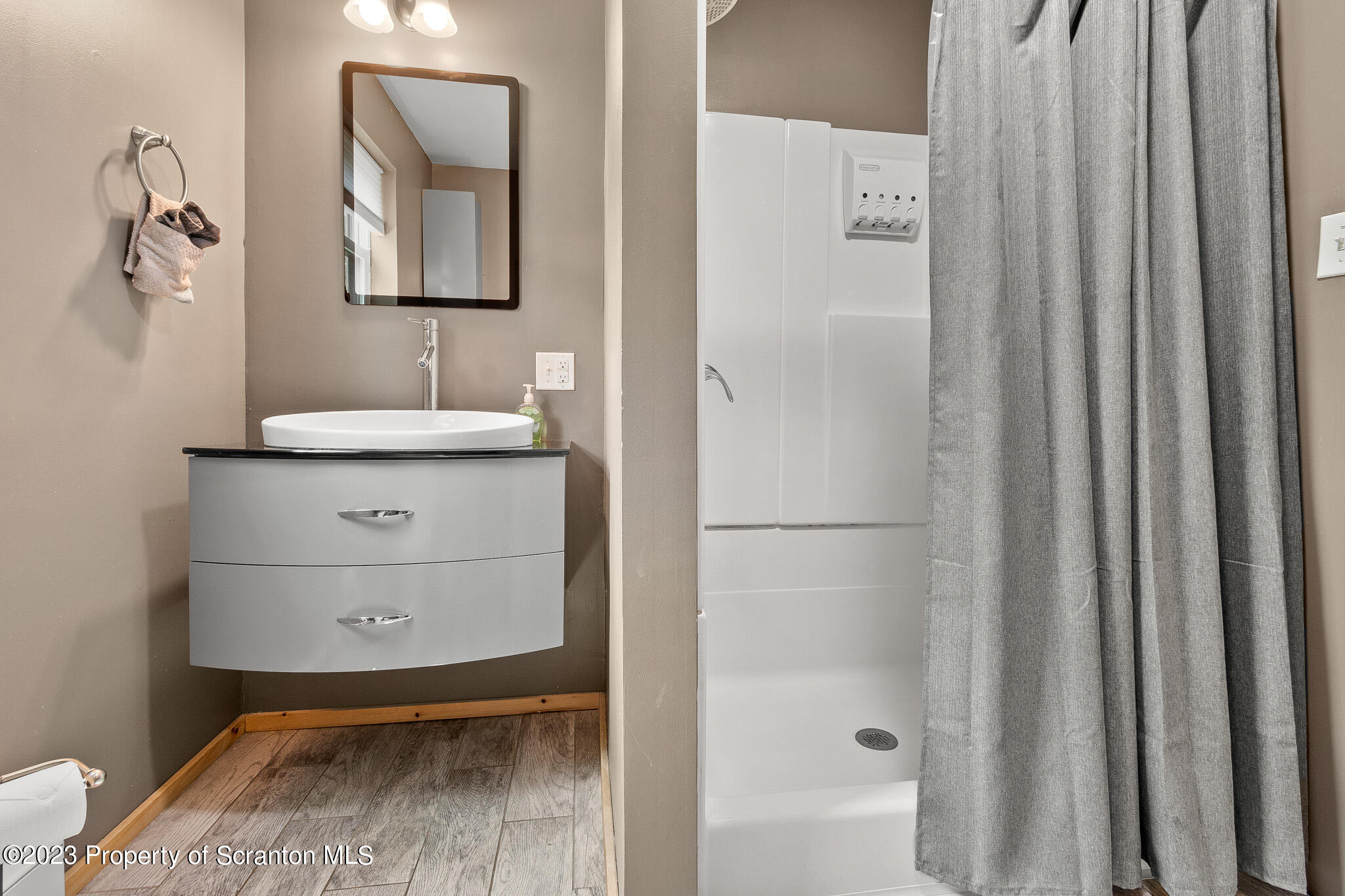 311 River Road Falls, PA 18615 - Photo 24 of 30 a bathroom with a granite countertop sink a mirror and shower