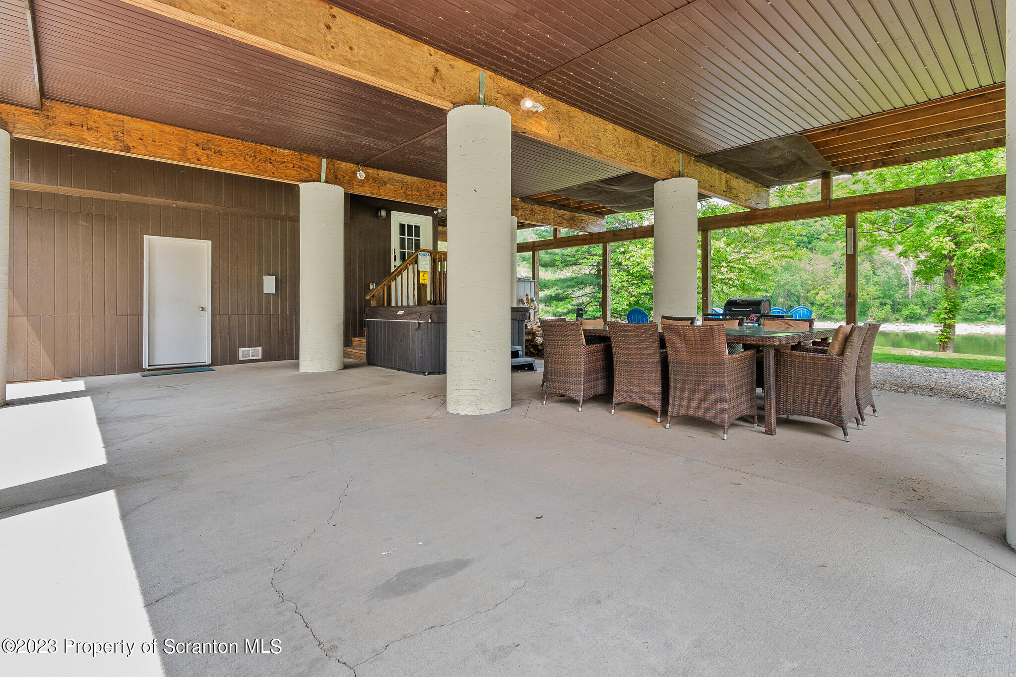 311 River Road Falls, PA 18615 - Photo 28 of 30 a view of a patio with table and chairs potted plants with wooden floor