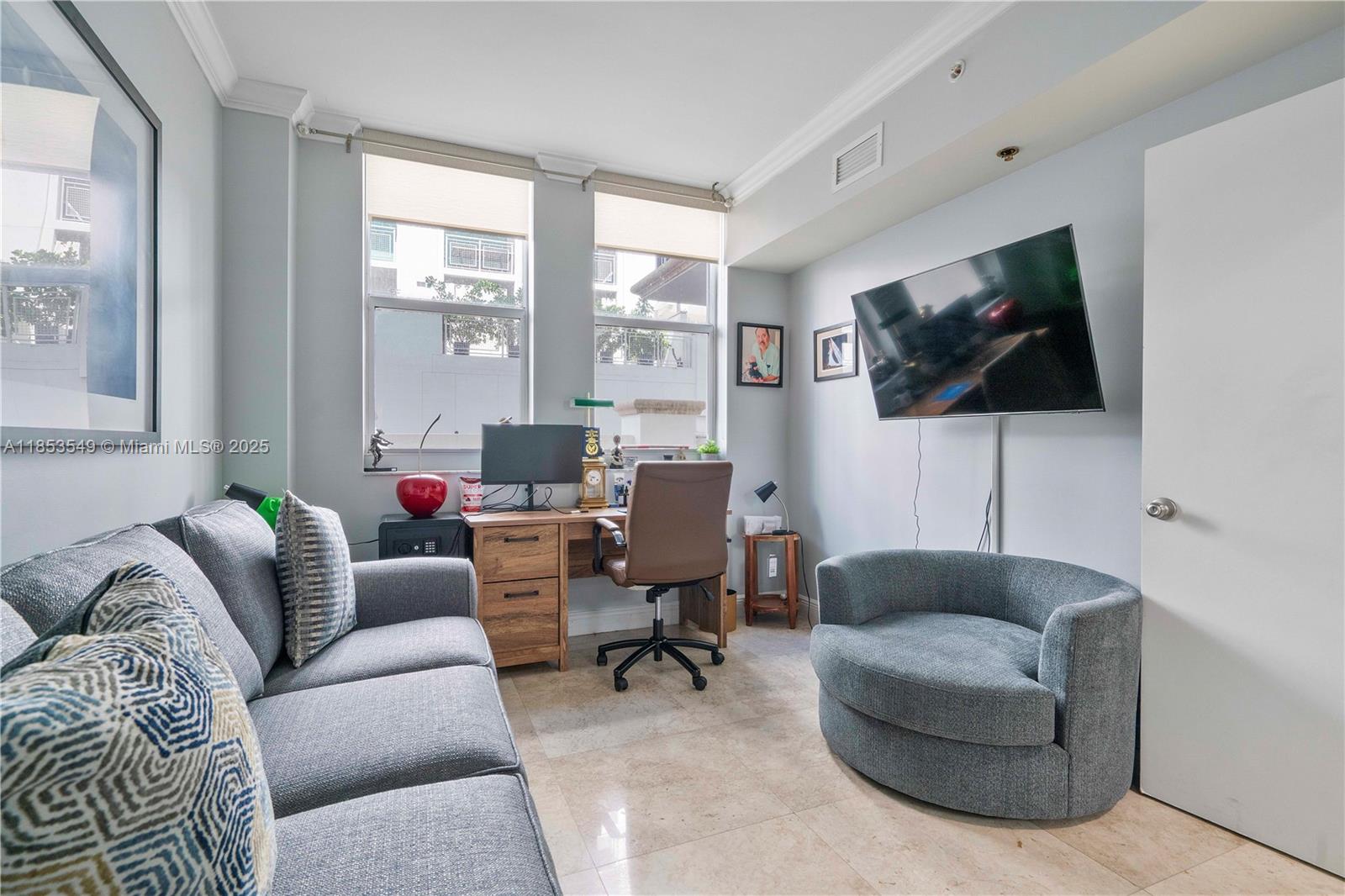 4100 Salzedo Street, Unit 409 Coral Gables, FL 33146 - Photo 11 of 45 a living room with furniture and a flat screen tv