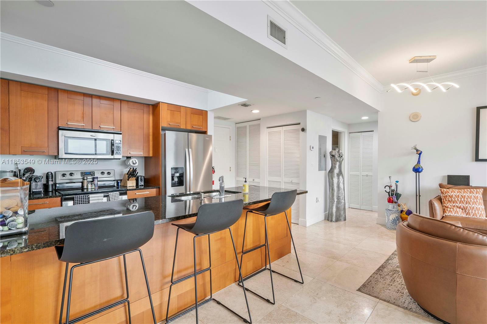4100 Salzedo Street, Unit 409 Coral Gables, FL 33146 - Photo 13 of 45 a living room with stainless steel appliances kitchen island granite countertop furniture and a kitchen view
