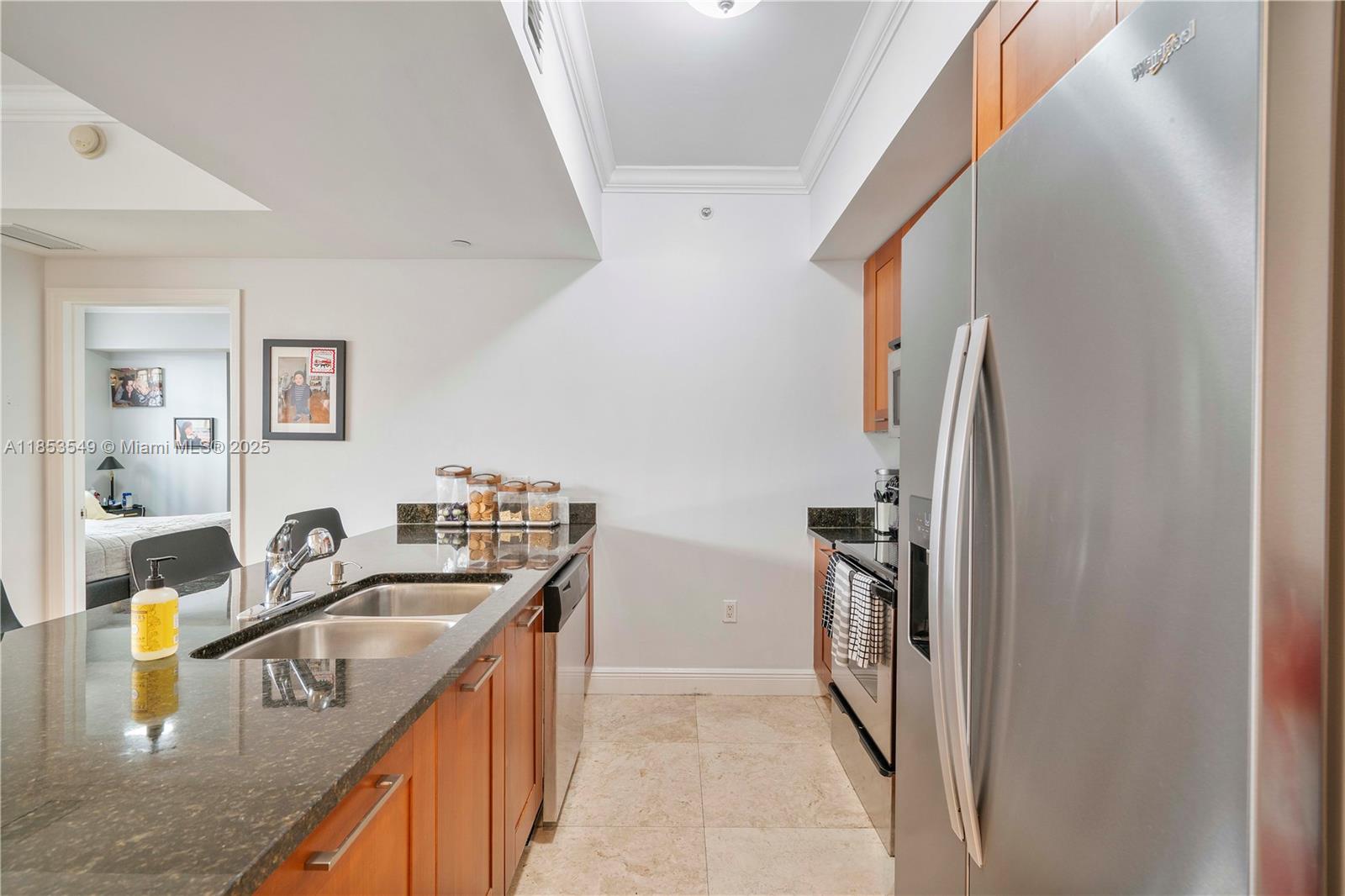 4100 Salzedo Street, Unit 409 Coral Gables, FL 33146 - Photo 15 of 45 a kitchen with stainless steel appliances granite countertop a sink stove and refrigerator