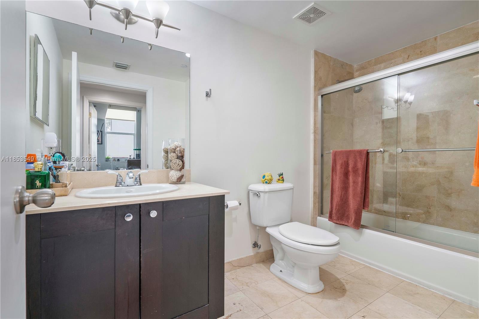 4100 Salzedo Street, Unit 409 Coral Gables, FL 33146 - Photo 17 of 45 a bathroom with a sink toilet and shower