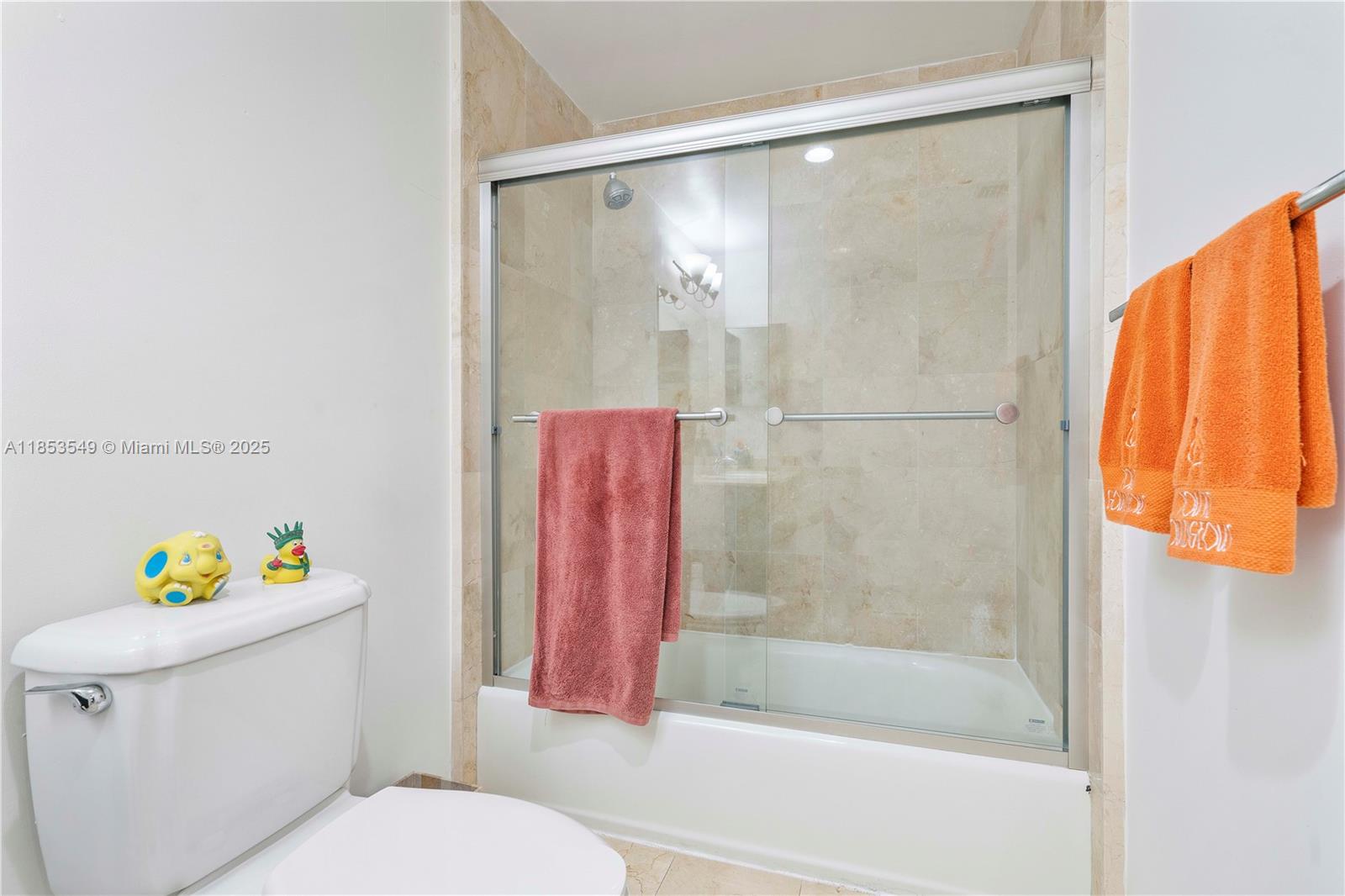 4100 Salzedo Street, Unit 409 Coral Gables, FL 33146 - Photo 18 of 45 a white toilet sitting next to a bath tub