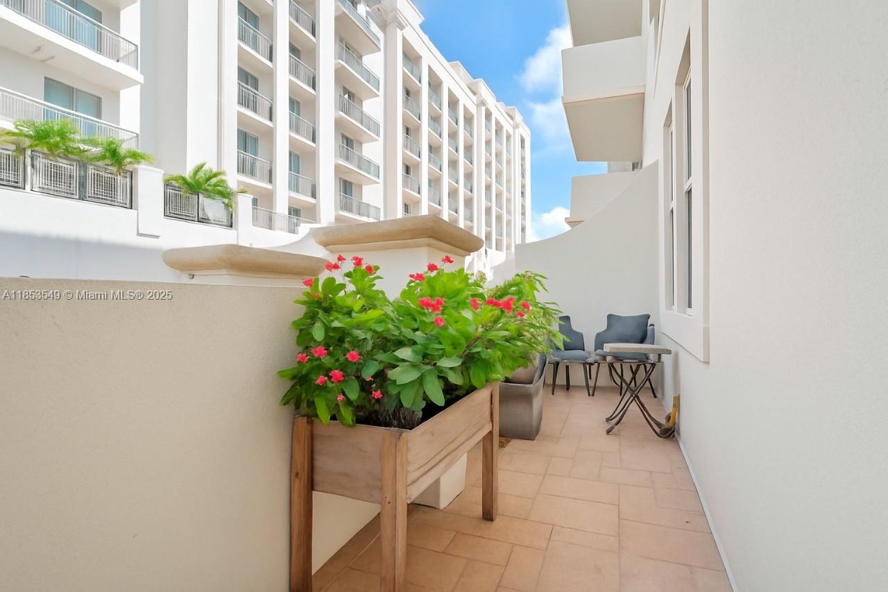 4100 Salzedo Street, Unit 409 Coral Gables, FL 33146 - Photo 24 of 45 a potted plant sitting in front of a building
