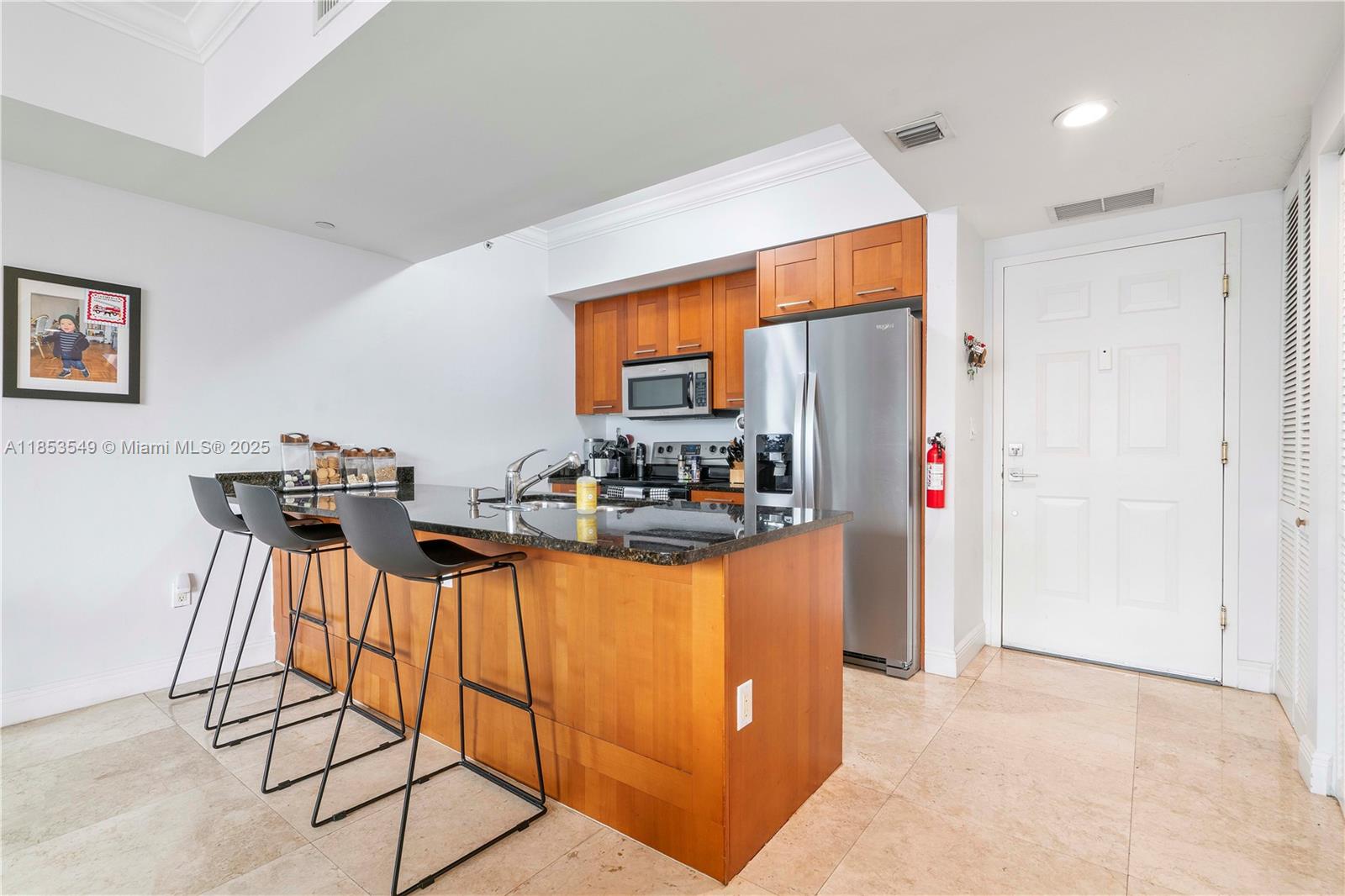 4100 Salzedo Street, Unit 409 Coral Gables, FL 33146 - Photo 5 of 45 a kitchen with stainless steel appliances a refrigerator and a stove