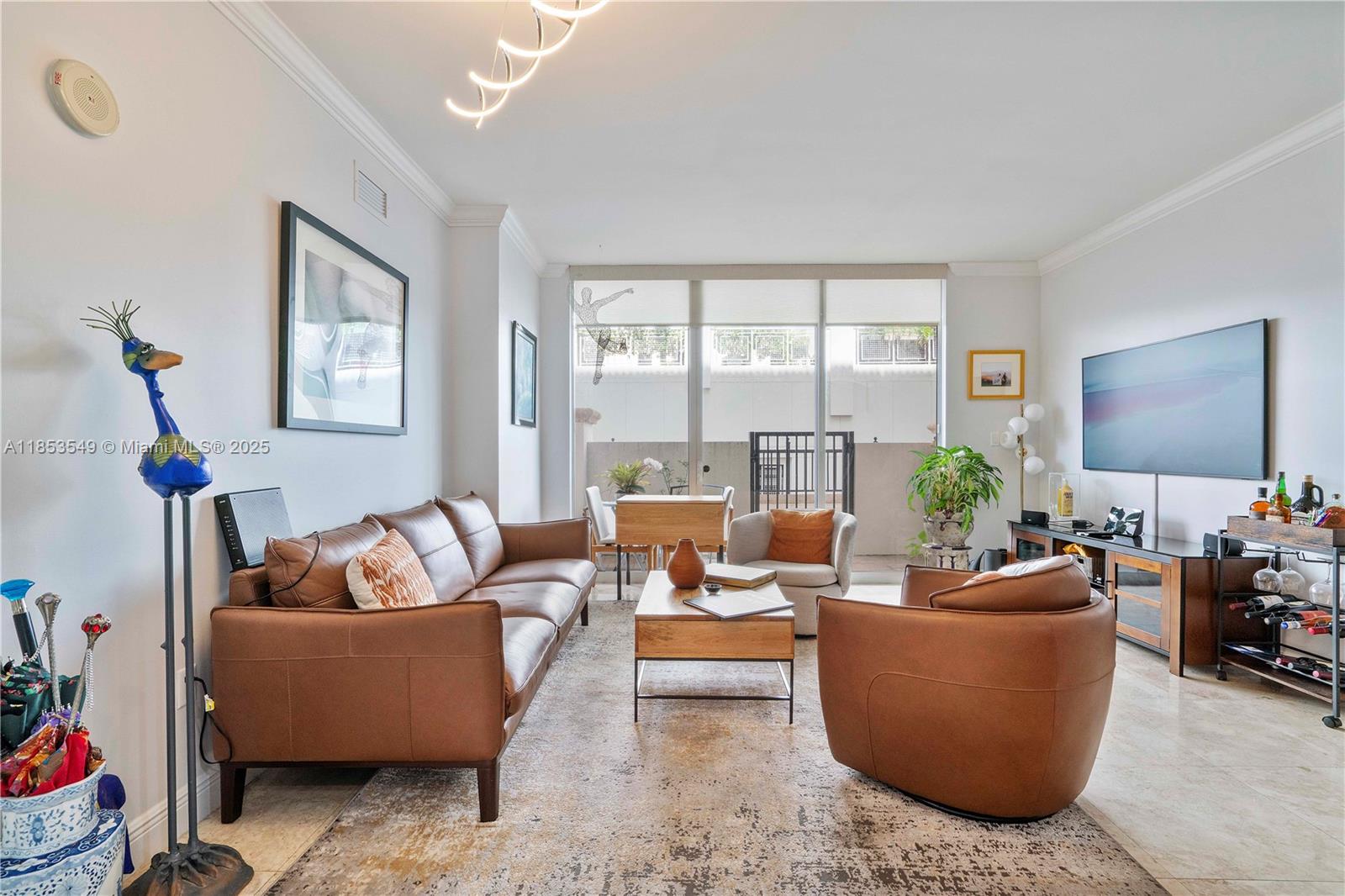 4100 Salzedo Street, Unit 409 Coral Gables, FL 33146 - Photo 6 of 45 a living room with furniture and a potted plant