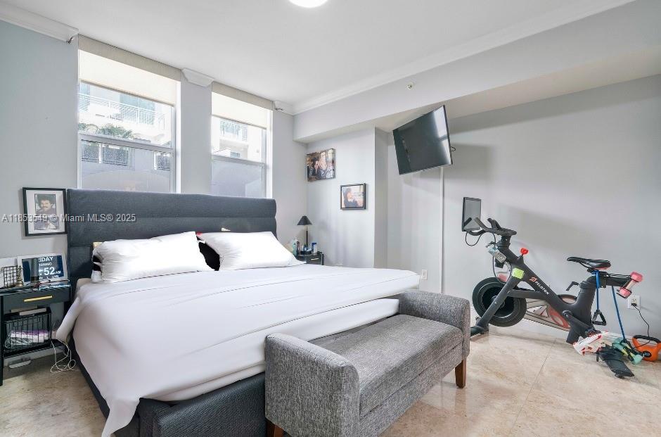 4100 Salzedo Street, Unit 409 Coral Gables, FL 33146 - Photo 7 of 45 a bedroom with a bed and a flat screen tv