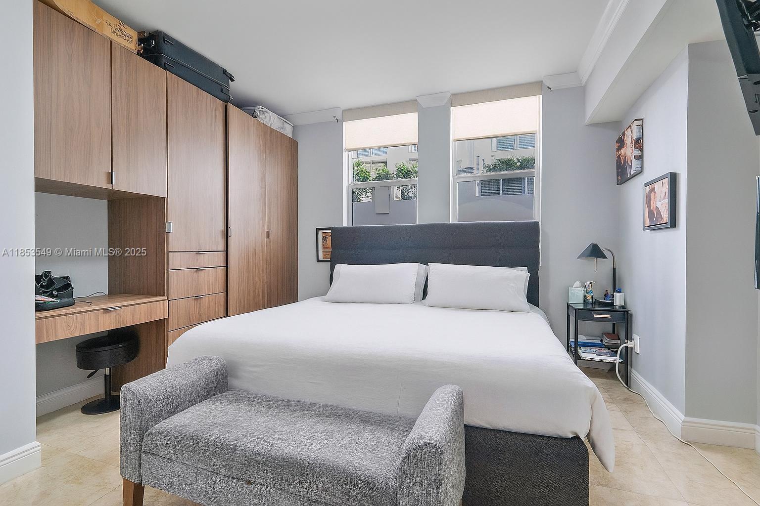 4100 Salzedo Street, Unit 409 Coral Gables, FL 33146 - Photo 8 of 45 a bedroom with a large bed and a window