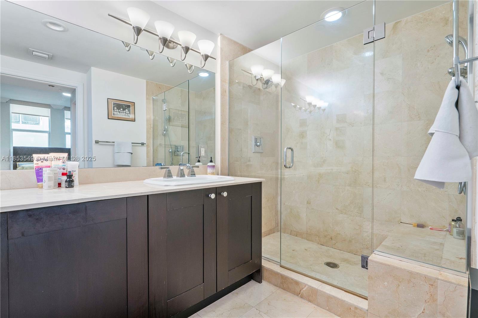 4100 Salzedo Street, Unit 409 Coral Gables, FL 33146 - Photo 9 of 45 a bathroom with a shower sink double and mirror