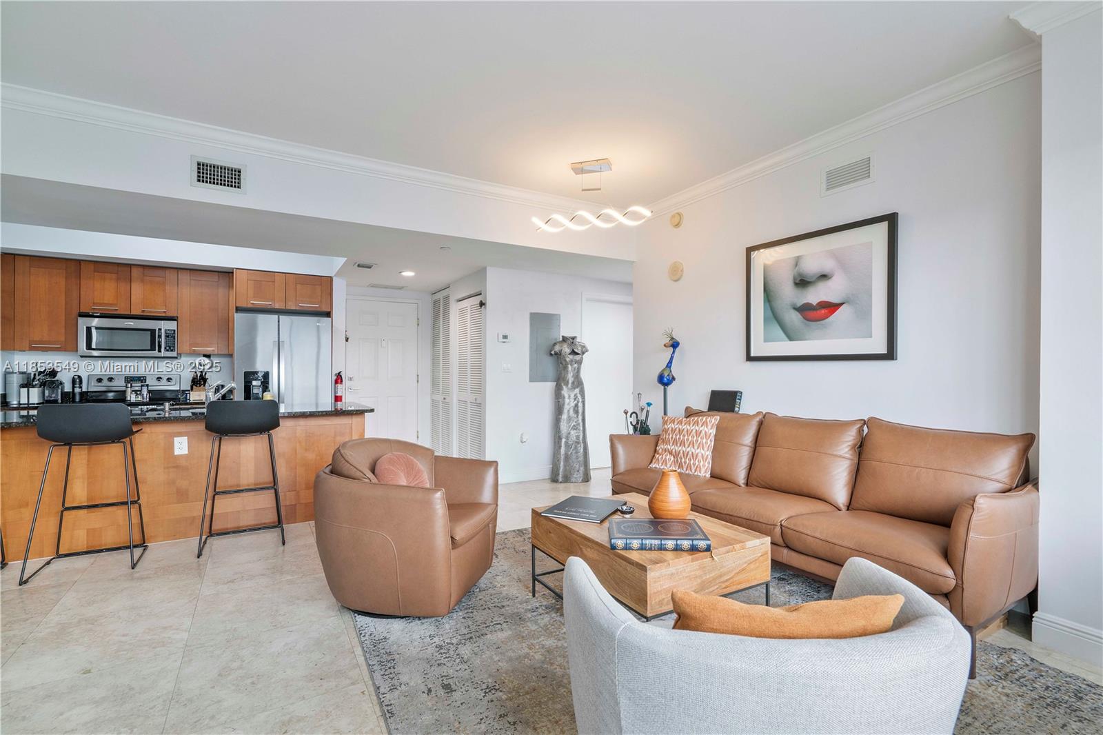 4100 Salzedo Street, Unit 409 Coral Gables, FL 33146 - Photo 10 of 45 a living room with furniture and a kitchen view