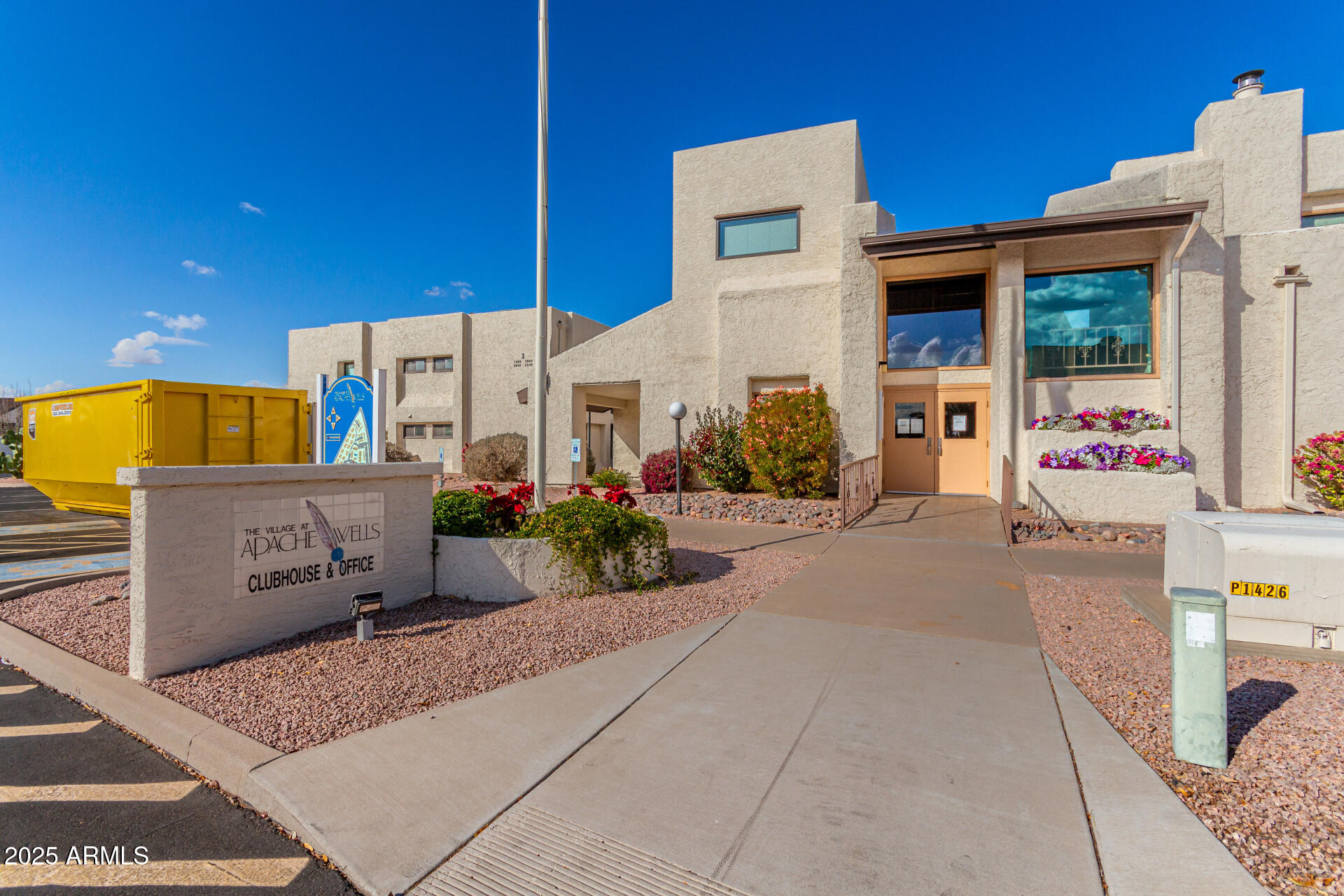 a front view of a building with potted plants