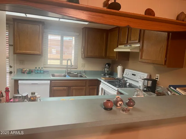 a kitchen with a sink a stove and cabinets