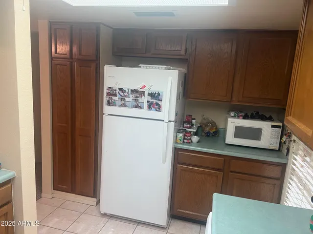 a kitchen with stainless steel appliances a refrigerator and cabinets