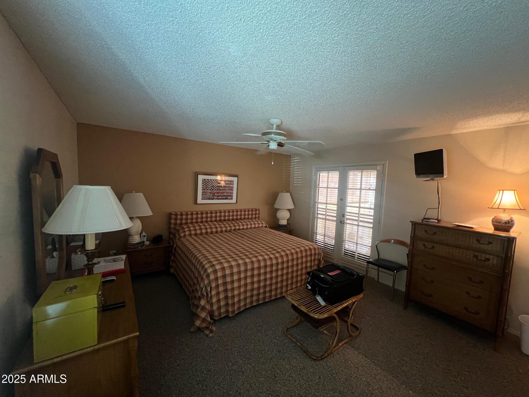 5518 East Lindstrom Lane, Unit 1044 Mesa, AZ 85215 - Photo 16 of 30 a bedroom with a bed window and couch