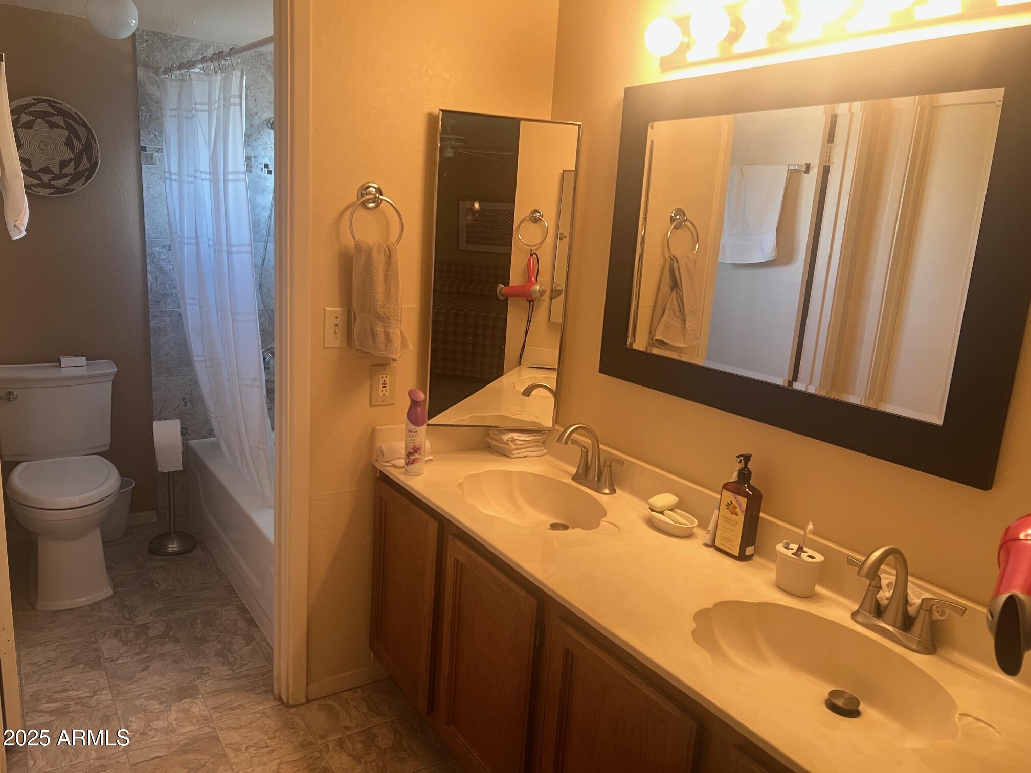 5518 East Lindstrom Lane, Unit 1044 Mesa, AZ 85215 - Photo 18 of 30 a bathroom with a double vanity sink and mirror