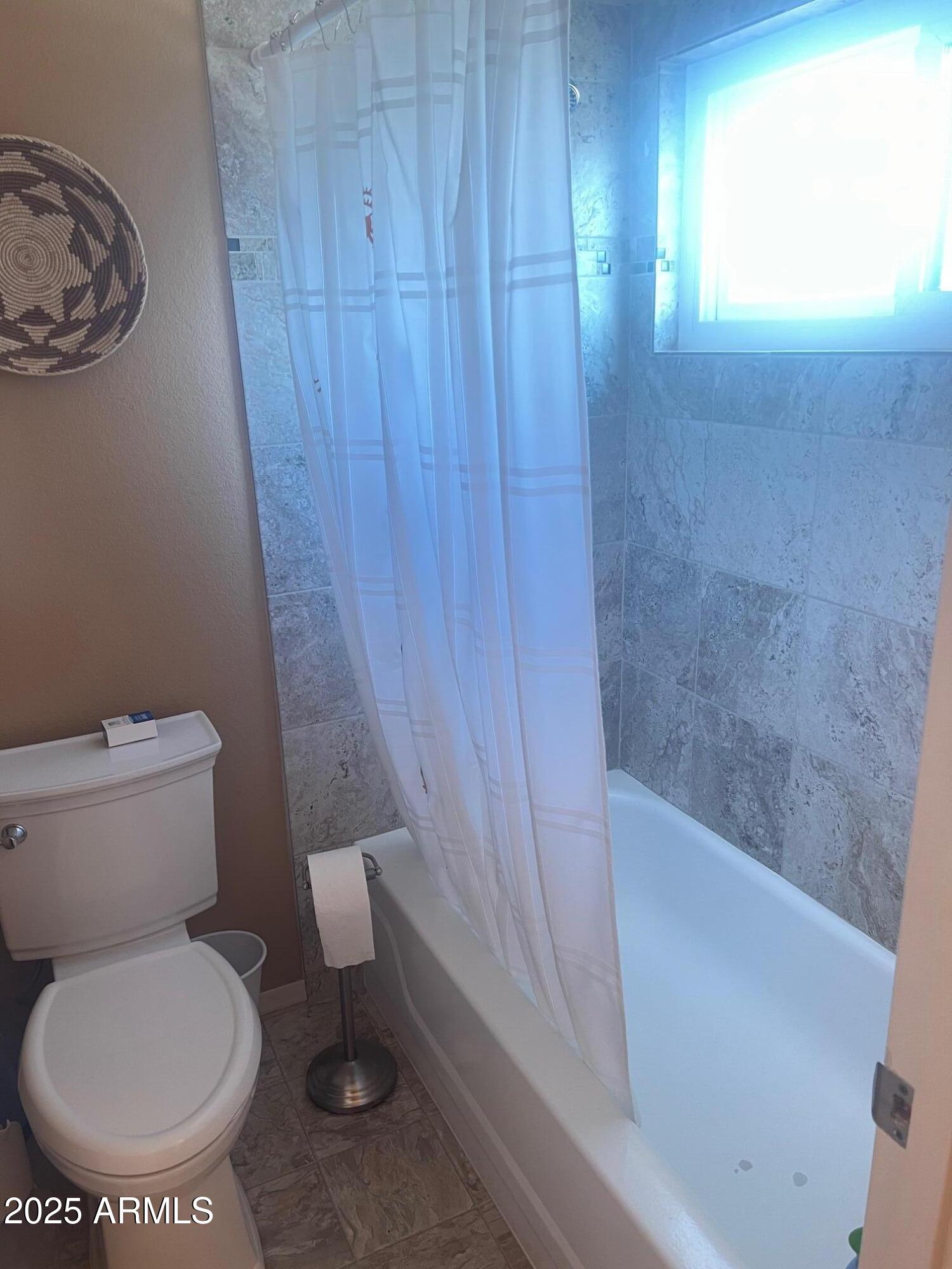 5518 East Lindstrom Lane, Unit 1044 Mesa, AZ 85215 - Photo 19 of 30 a bathroom with a toilet and a bathtub