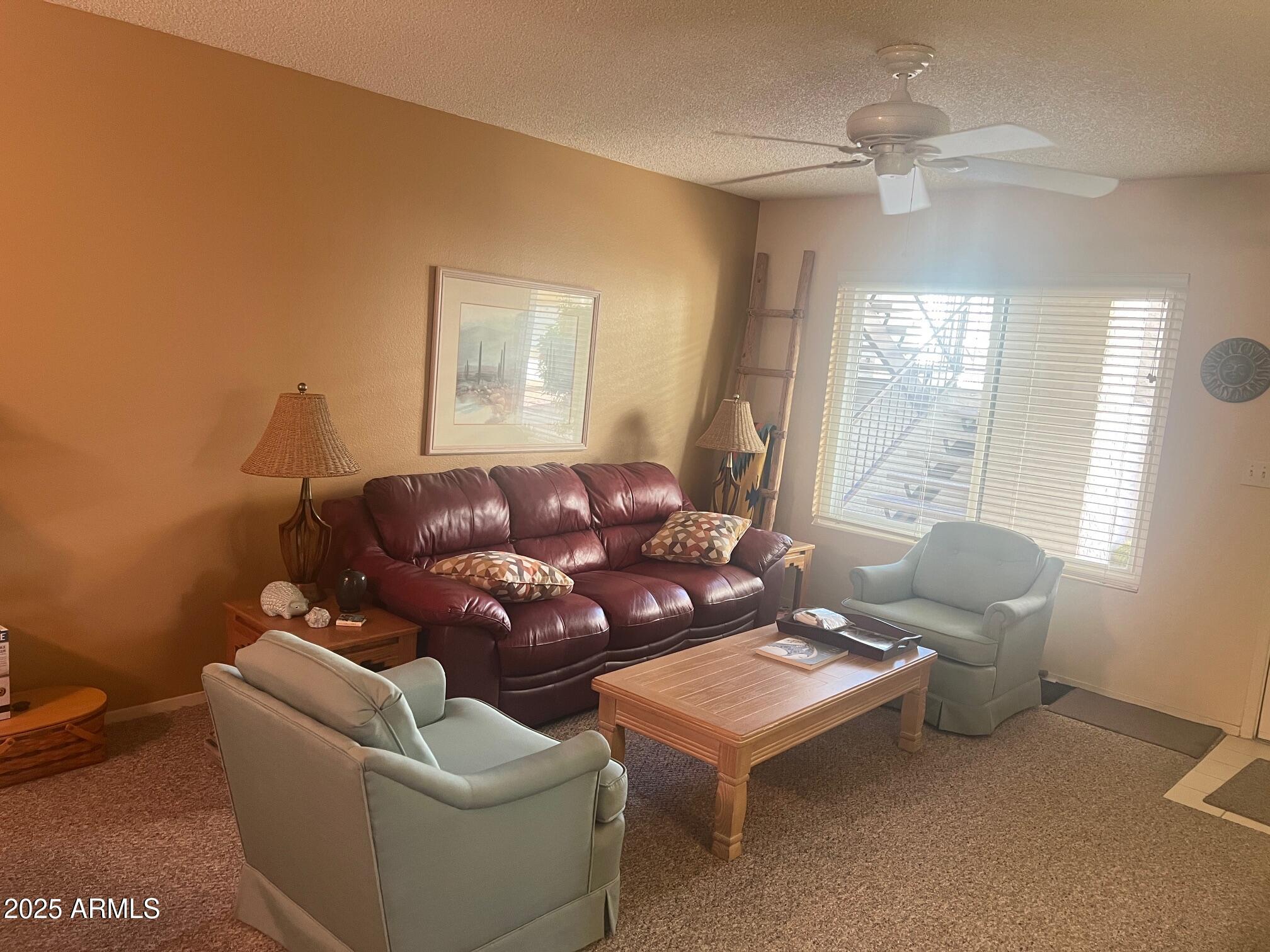 5518 East Lindstrom Lane, Unit 1044 Mesa, AZ 85215 - Photo 21 of 30 a living room with furniture and a large window