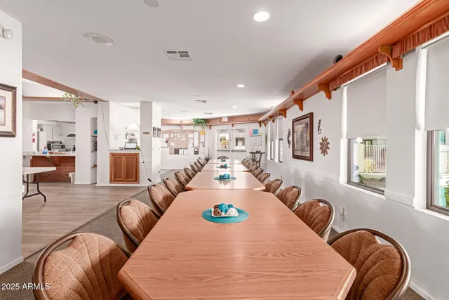 a large living room with stainless steel appliances kitchen island granite countertop a couch and chairs