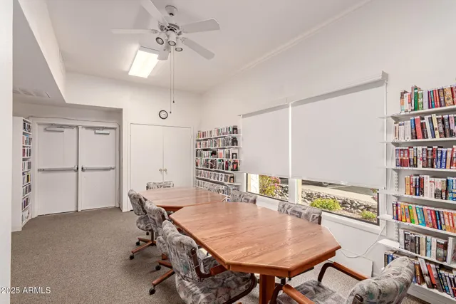 a dining room with furniture and a book shelf