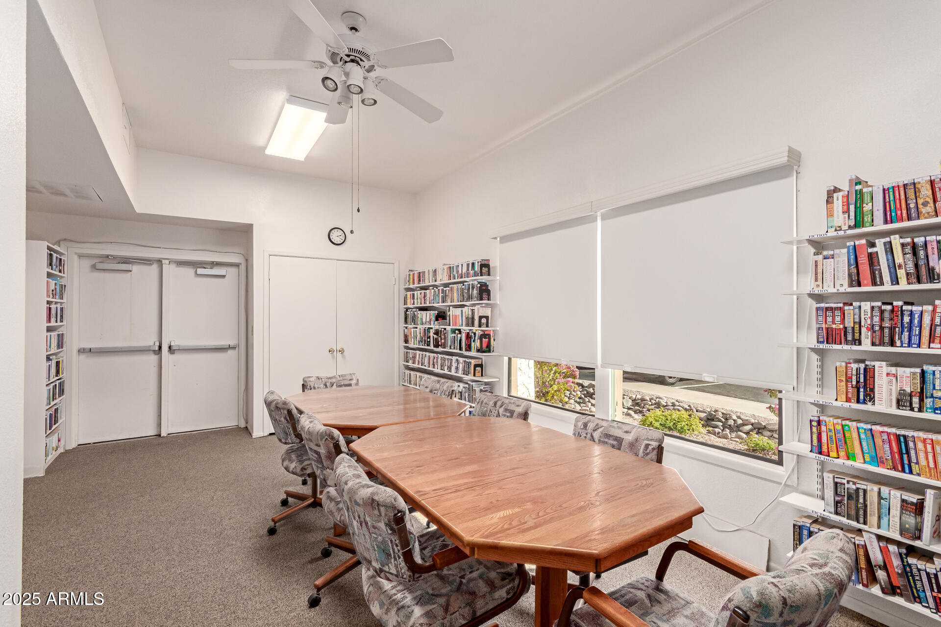5518 East Lindstrom Lane, Unit 1044 Mesa, AZ 85215 - Photo 5 of 30 a dining room with furniture and a book shelf