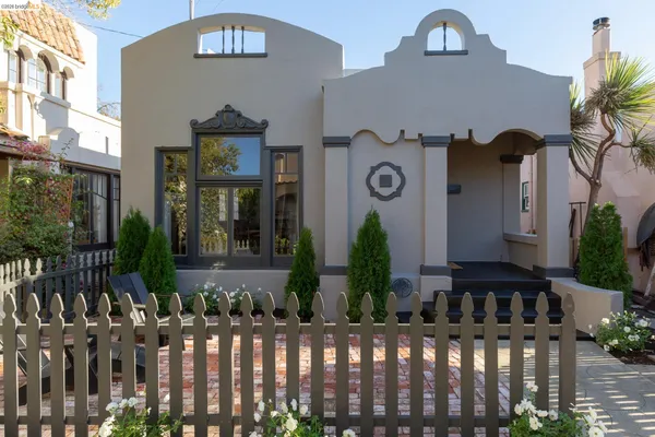 a view of a house with a small yard and plants