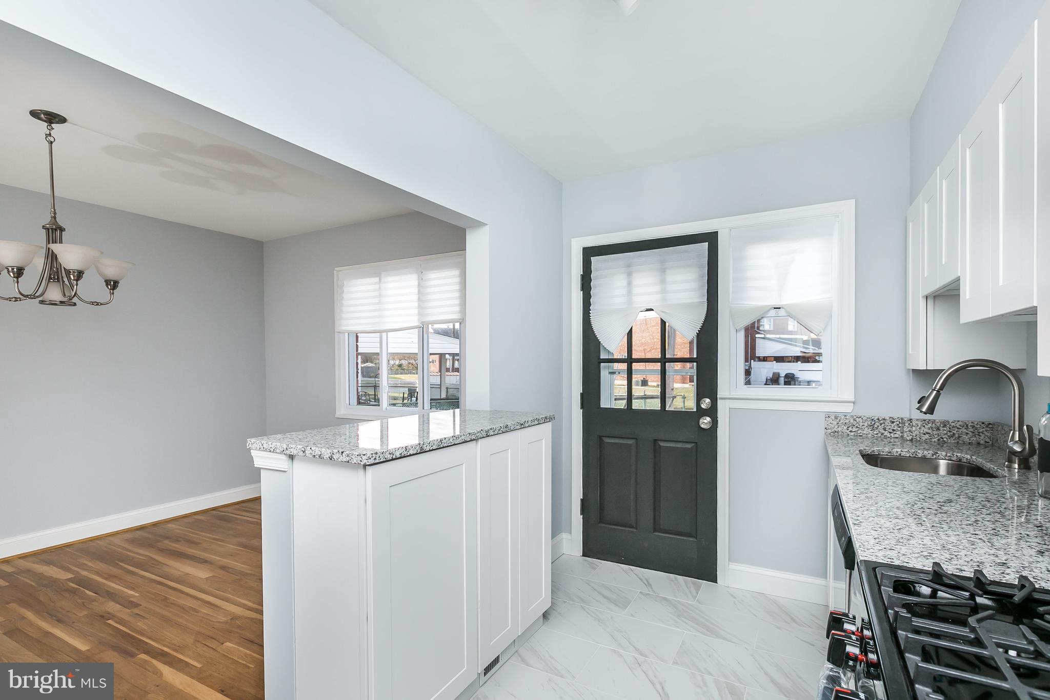 7808 Charlesmont Road Baltimore, MD 21222 - Photo 10 of 32 a kitchen with a refrigerator and countertop