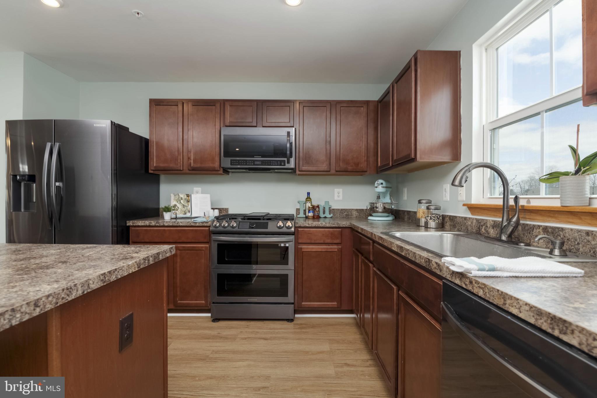 10114 Blansford Way Middle River, MD 21220 - Photo 12 of 41 a kitchen with granite countertop a sink stove and refrigerator