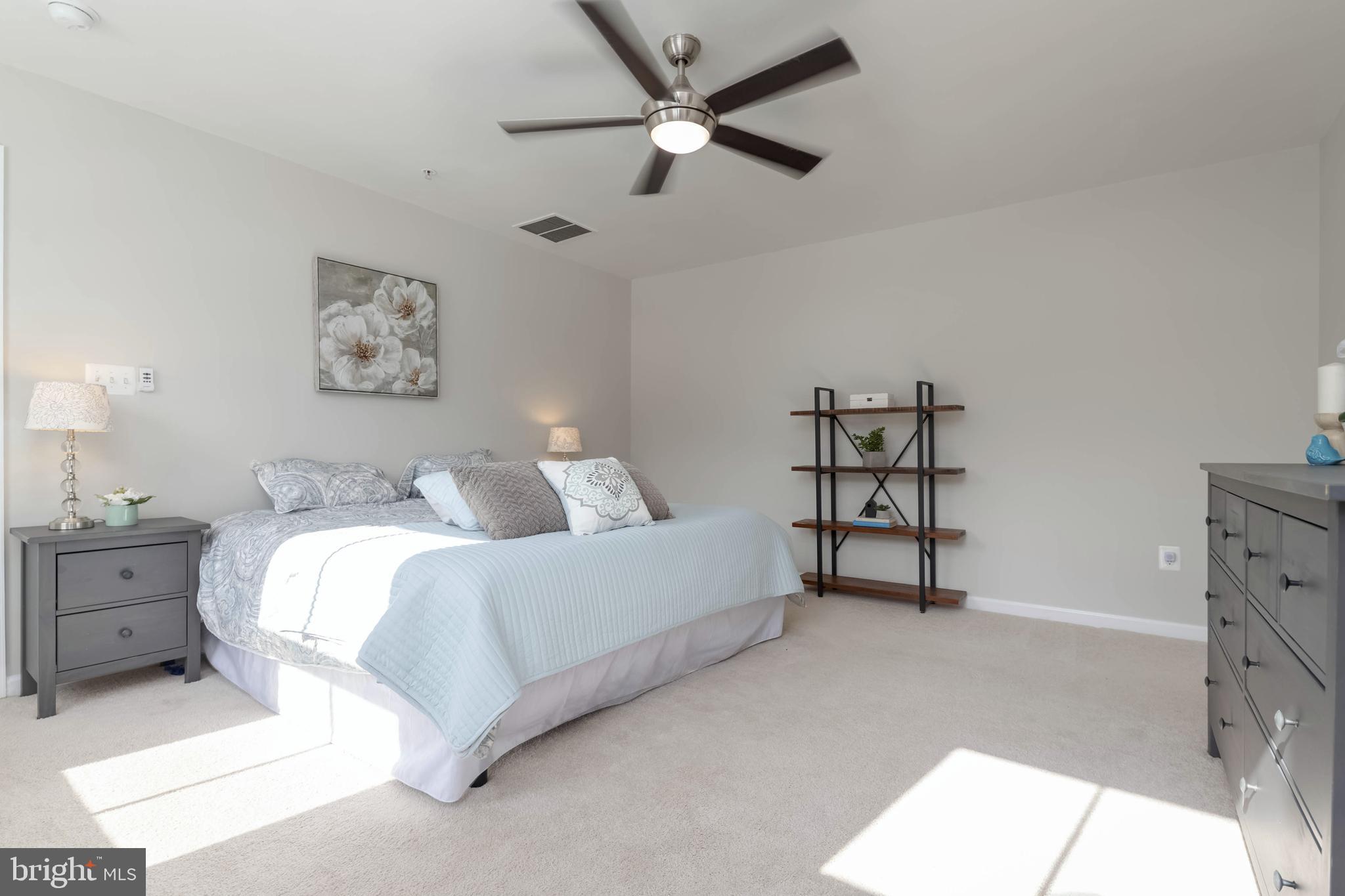 10114 Blansford Way Middle River, MD 21220 - Photo 17 of 41 a spacious bedroom with a bed and a ceiling fan