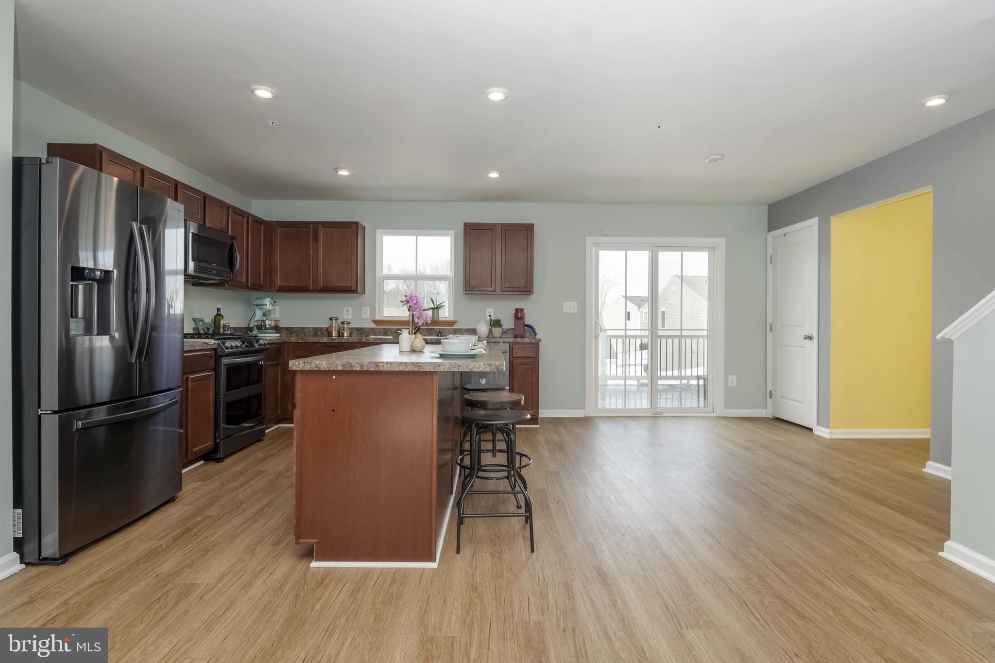 10114 Blansford Way Middle River, MD 21220 - Photo 7 of 41 a kitchen with a refrigerator a sink and a stove top oven