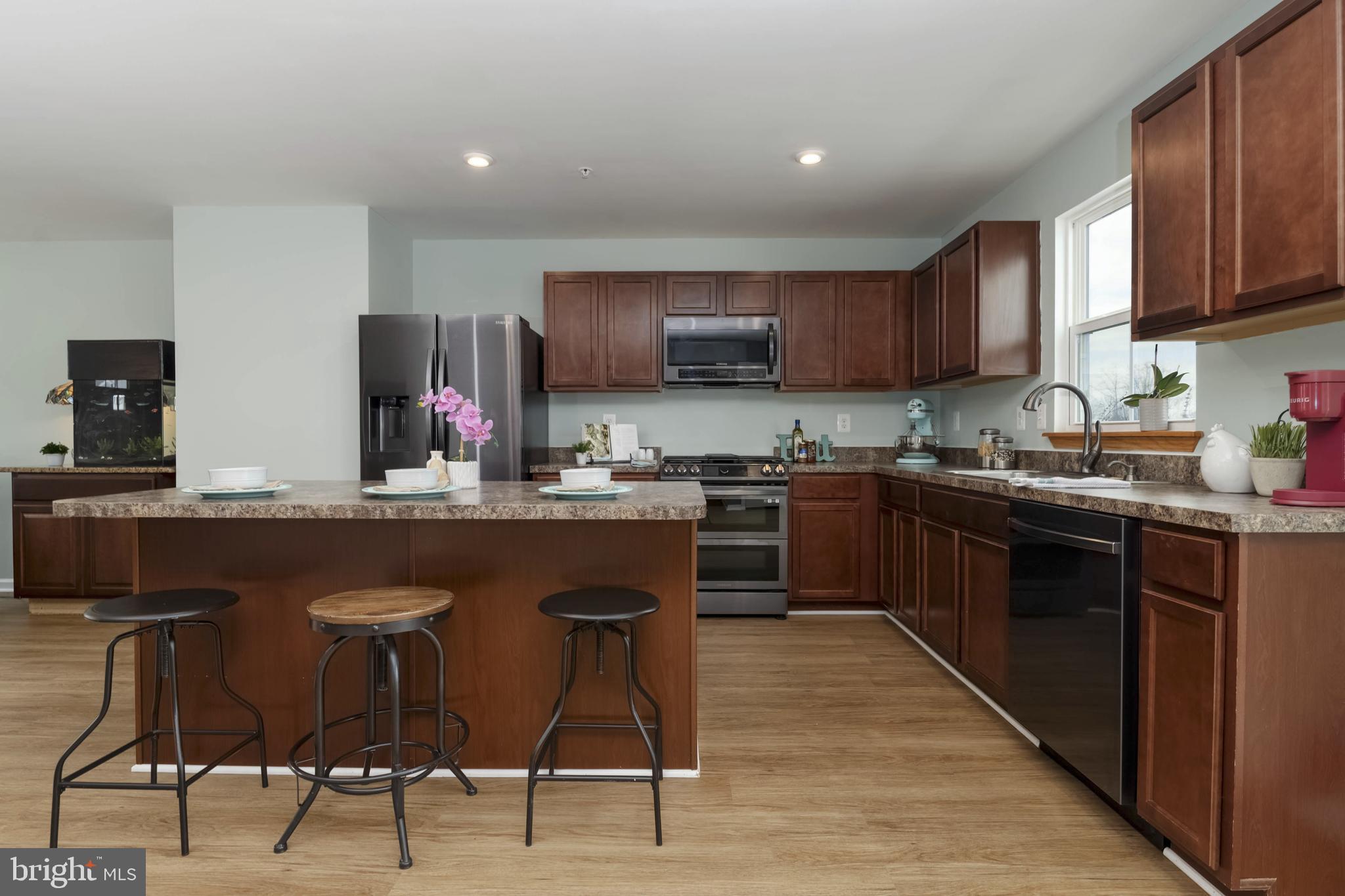 10114 Blansford Way Middle River, MD 21220 - Photo 10 of 41 a kitchen with stainless steel appliances granite countertop a sink a stove a refrigerator cabinets and a dining table