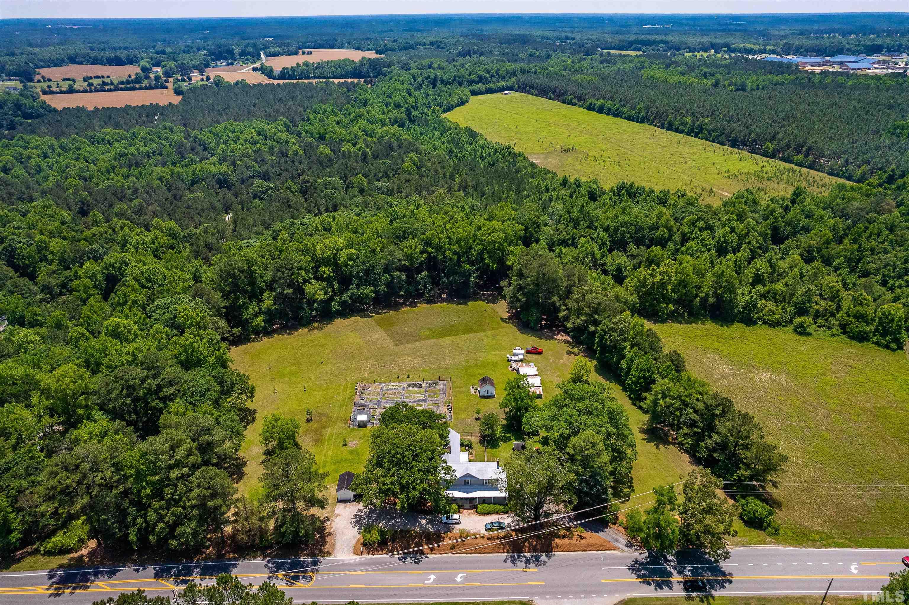6467 Cleveland Road Clayton, NC 27520 - Photo 2 of 54 Surrounded by a nursery and a 70 acre homesteader privacy abounds.