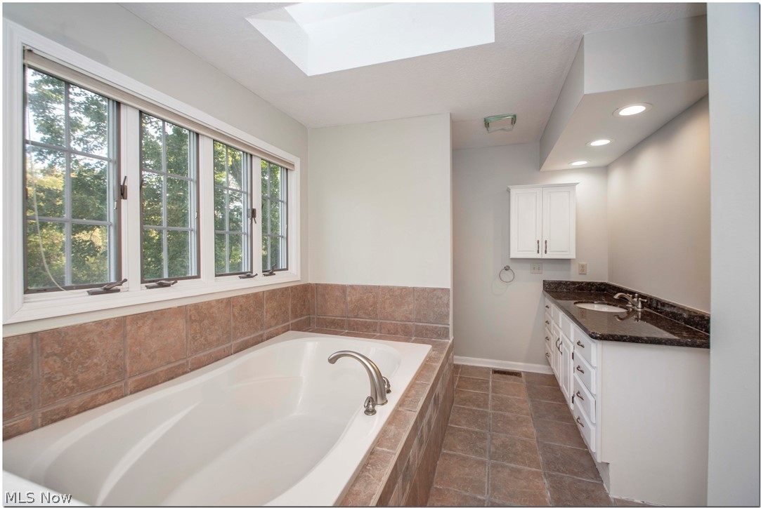 32099 Pinetree Road Pepper Pike, OH 44124 - Photo 21 of 35 Master bath w/garden tub newly refinished vanity sky light wall of windows