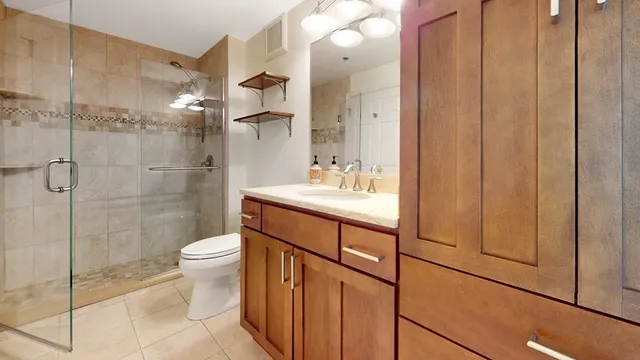 a bathroom with a sink toilet and shower