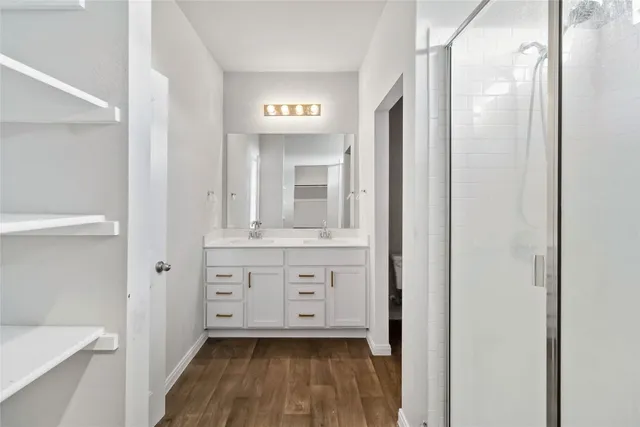 a bathroom with a sink a mirror and a shower