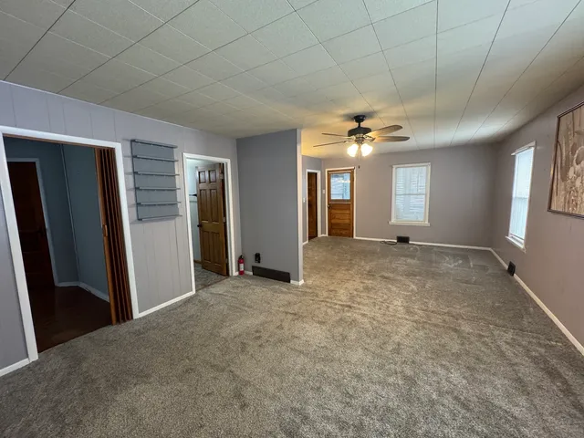 a view of a livingroom with a ceiling fan and window