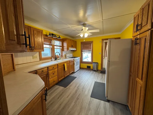 a kitchen with stainless steel appliances a refrigerator and a stove