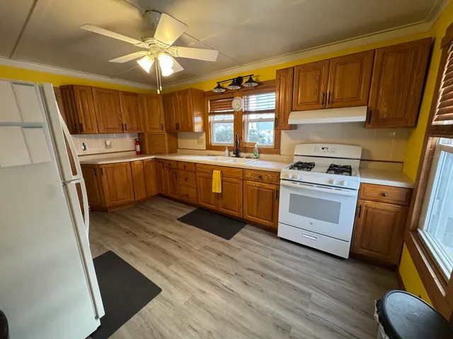 a kitchen with stove cabinets and wooden floor