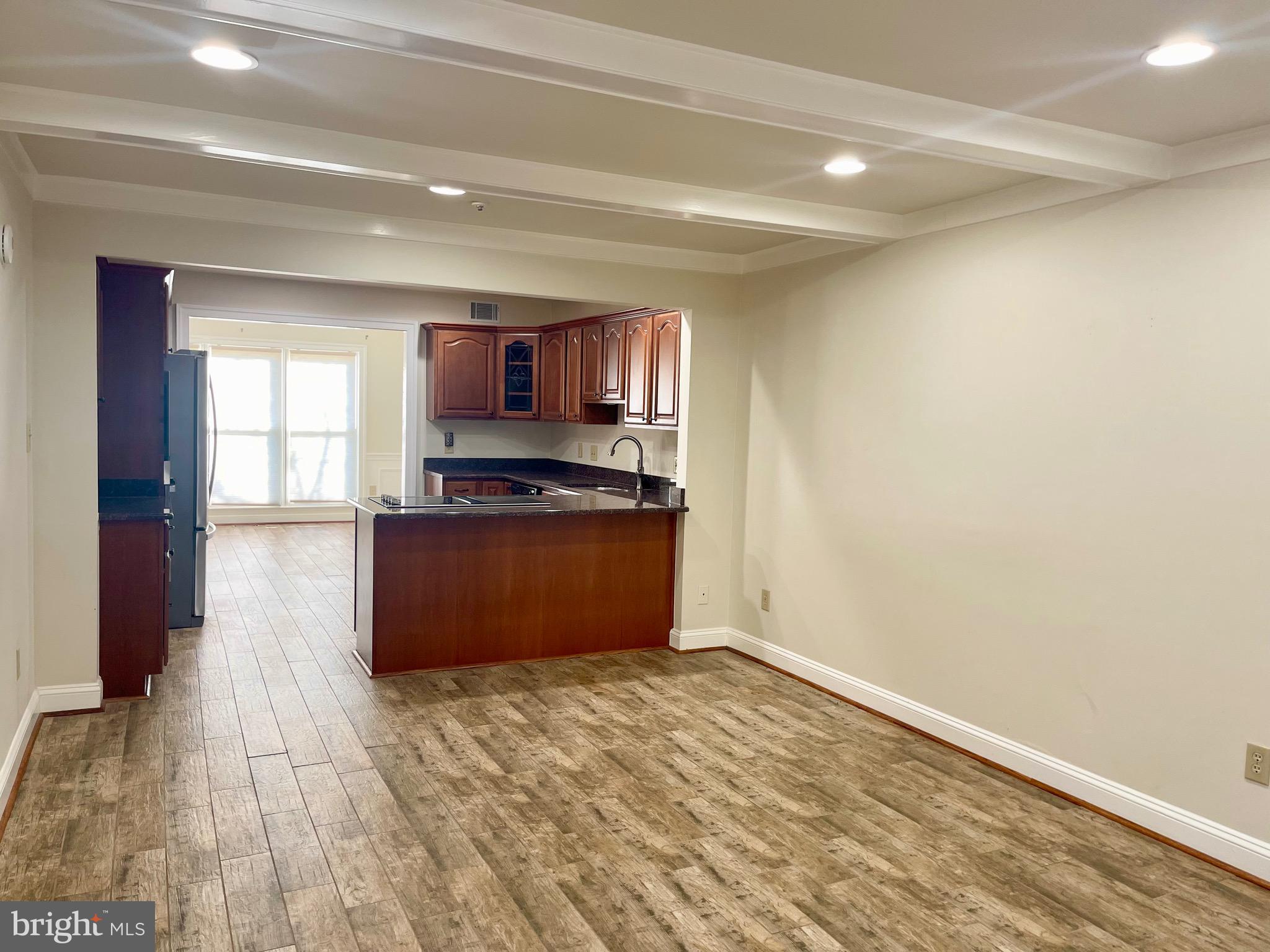 11803 Bishops Content Road Bowie, MD 20721 - Photo 11 of 54 a kitchen with a wooden floor and a stove top oven