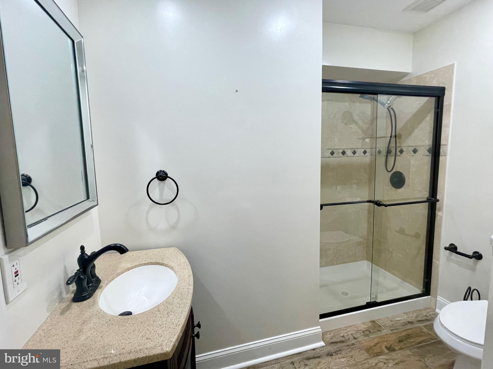 11803 Bishops Content Road Bowie, MD 20721 - Photo 22 of 54 a bathroom with a sink and a mirror