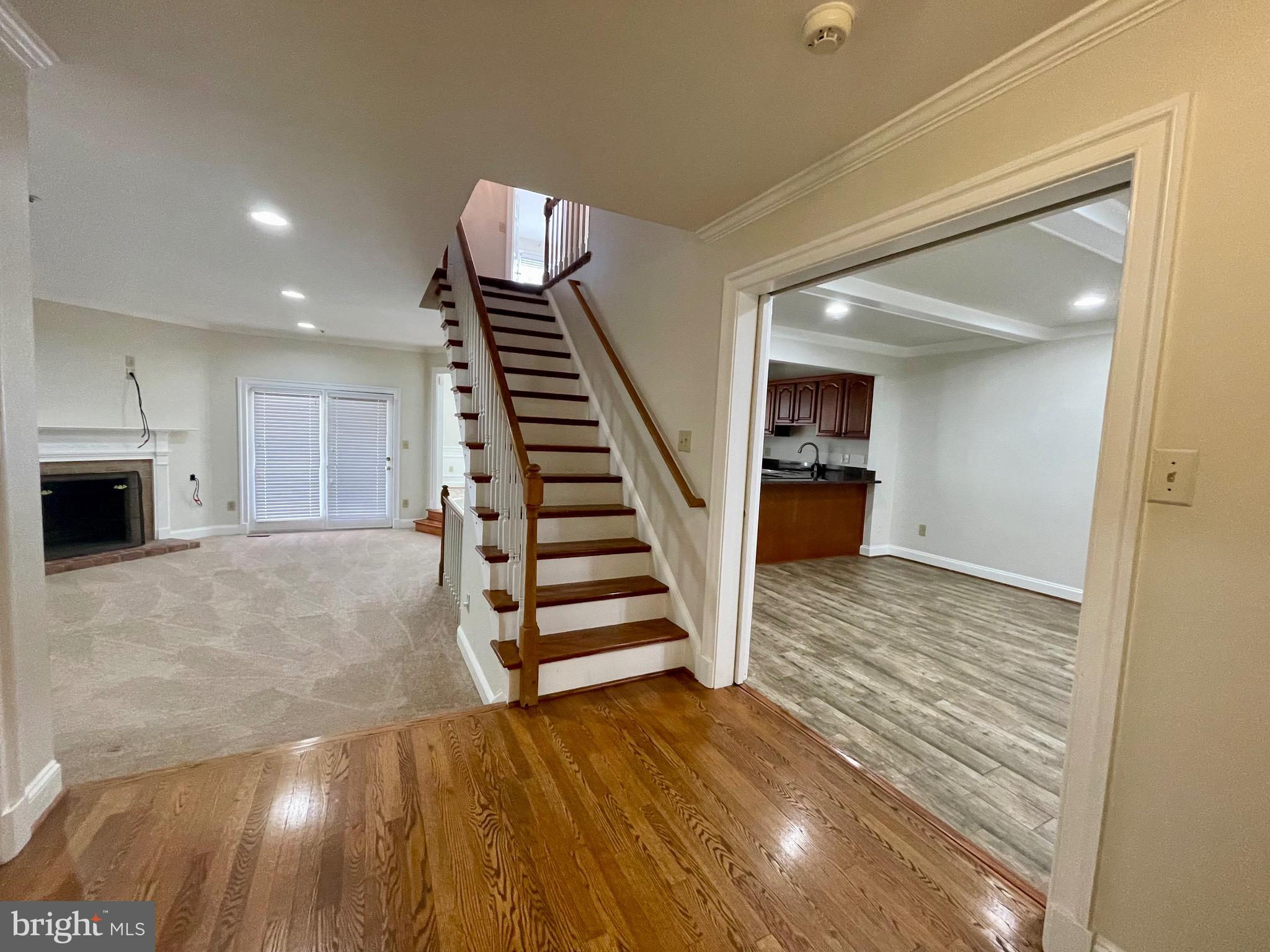 11803 Bishops Content Road Bowie, MD 20721 - Photo 4 of 54 a view of a livingroom with wooden floor and stairs