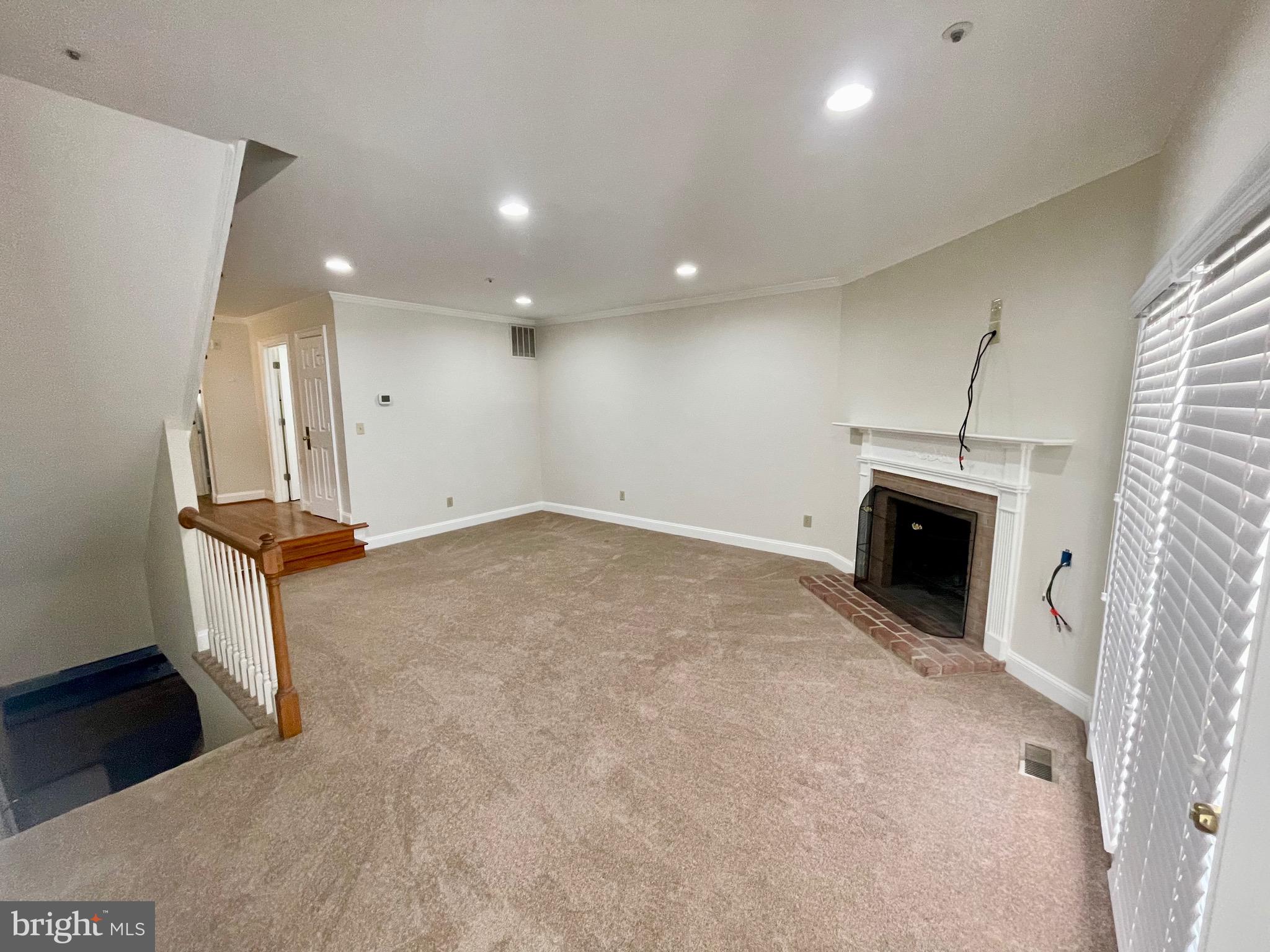 11803 Bishops Content Road Bowie, MD 20721 - Photo 7 of 54 an empty room with fireplace and windows