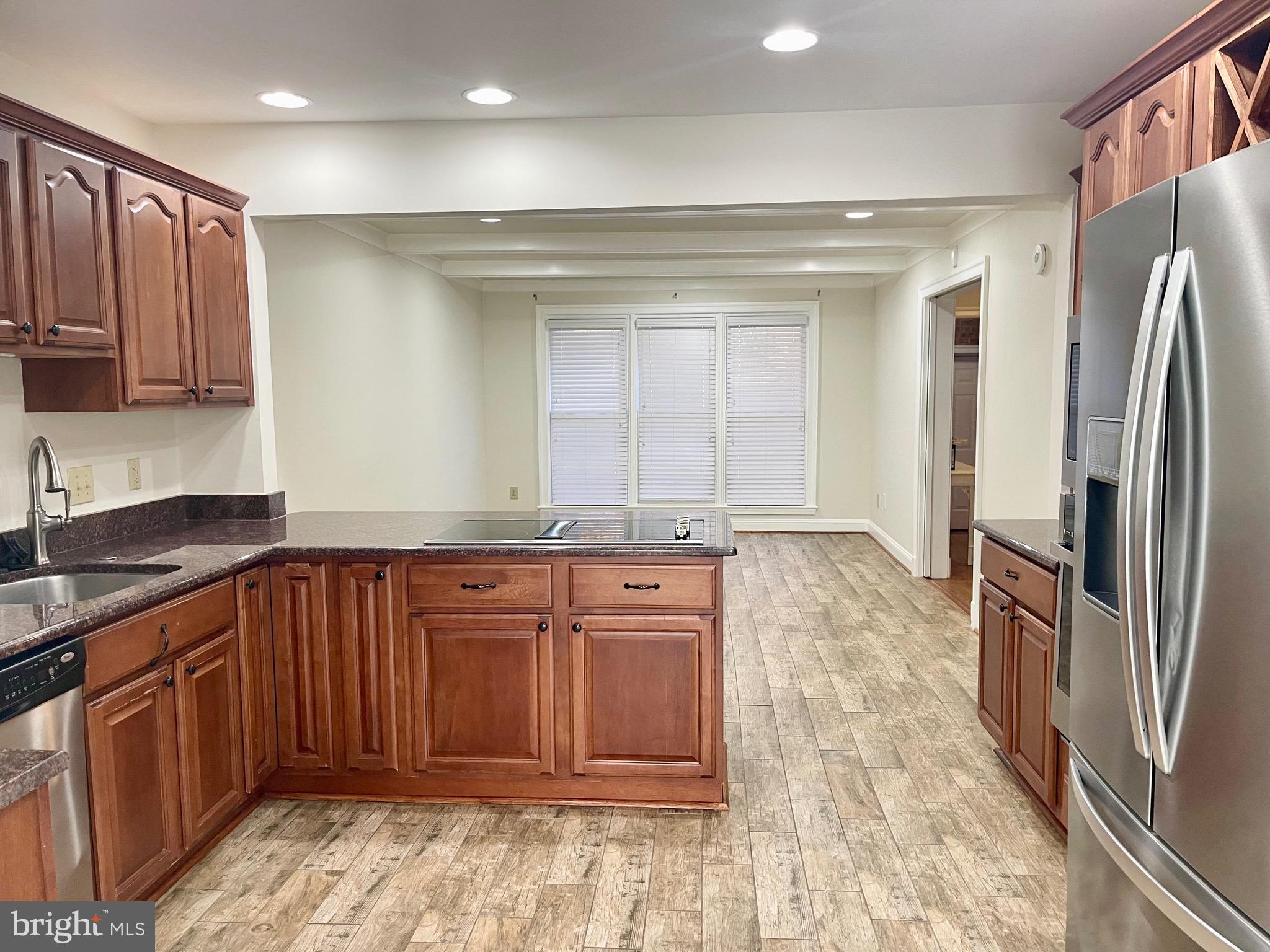 11803 Bishops Content Road Bowie, MD 20721 - Photo 10 of 54 a kitchen with stainless steel appliances granite countertop a refrigerator and a sink