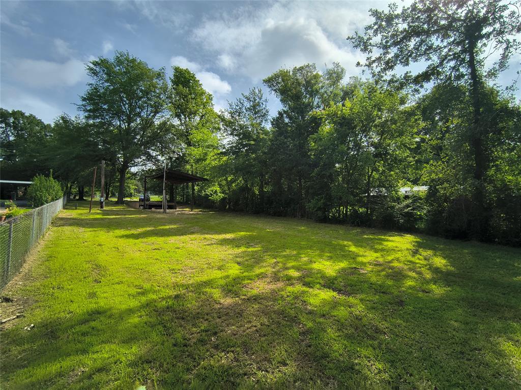 180 Arrowhead Street Mabank, TX 75156 - Photo 13 of 26 a swimming pool with trees in the background