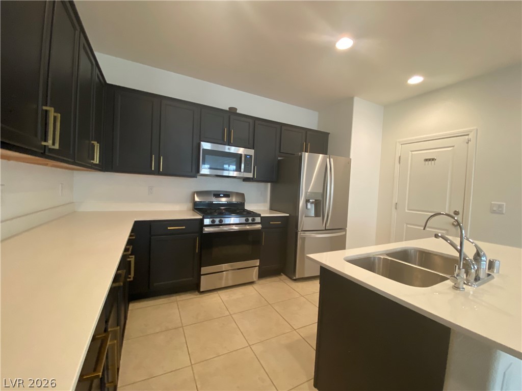 436 Cadence View Way Henderson, NV 89011 - Photo 4 of 36 A well-appointed kitchen showcasing contemporary black cabinetry and integrated stainless steel appliances.